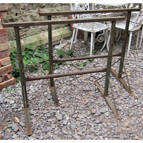 1545 - A pair of weathered iron work builders trestles with adjustable height