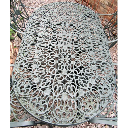 1548 - A contemporary green painted cast aluminium garden terrace table of oval form with decorative pierce... 