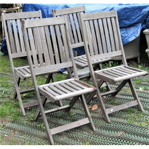 1555 - A set of four Winchester Collection weathered teak folding garden chairs with slatted seats and back... 