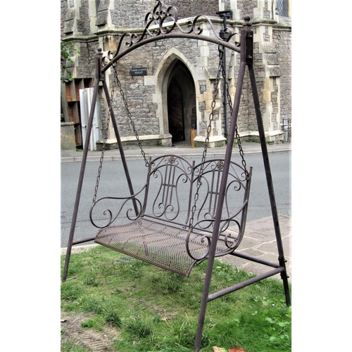 1560 - A contemporary tubular steel framed chain hung two seat garden swing, with shaped and pierced lattic... 