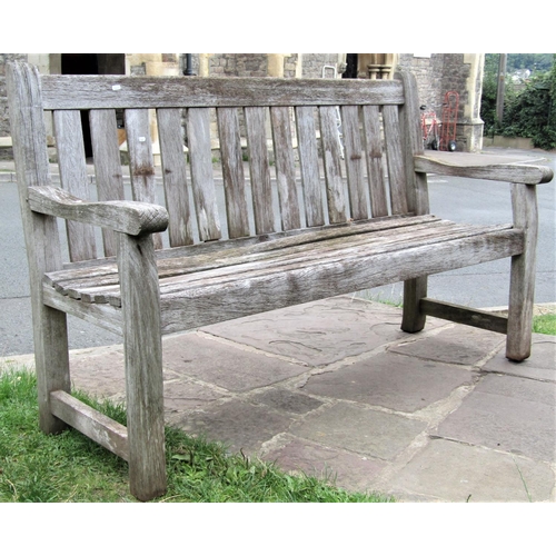 1561 - A vintage weathered teak garden bench with slatted seat and back (af) 150cm long