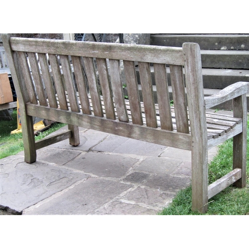 1561 - A vintage weathered teak garden bench with slatted seat and back (af) 150cm long