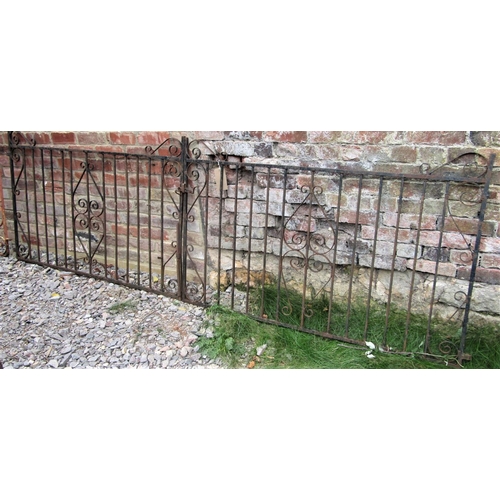 1537 - A pair of low ironwork driveway entrance gates with simple scroll detail, three metre span x 92cm hi... 