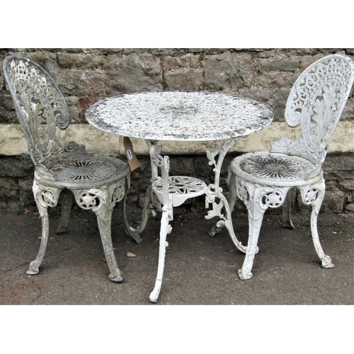 1502 - A cast aluminium garden terrace table with decorative circular pierced top, raised on scrolled suppo... 