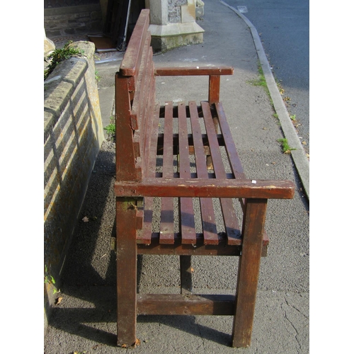 2030 - A stained soft wood three seat garden bench with slatted framework, 166 cm long