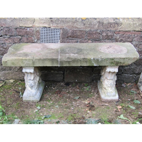 2040 - A weathered three sectional garden bench with later associated natural stone slab seat raised on a p... 