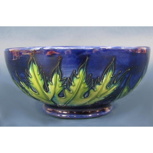 1017 - A Moorcroft dark blue ground bowl with buttercup decoration and with impressed marks to base, 16 cm ... 