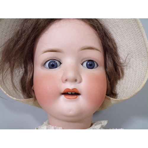 51 - Large German bisque head doll circa 1920's with closing blue eyes, open mouth with teeth and jointed... 