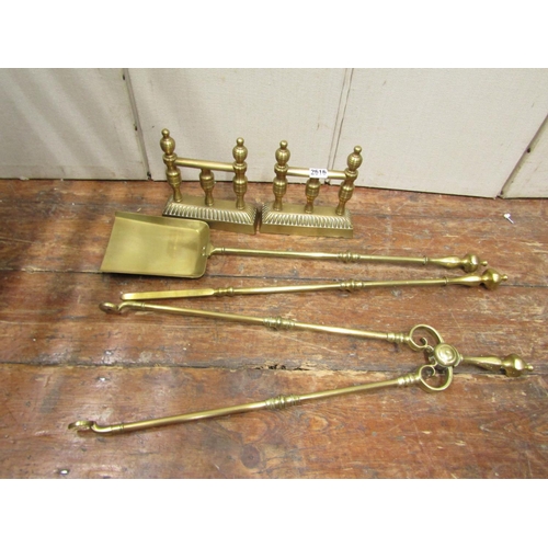 Set of three heavy brass fire irons, together with a pair of fire dogs on turned supports
