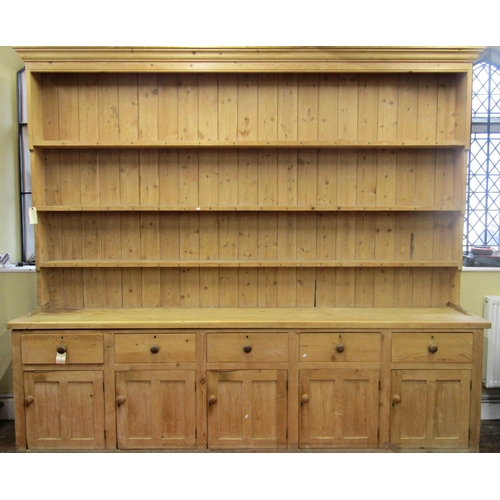 2588 - A truly massive Victorian stripped pine kitchen dresser, fitted with five deep drawers over five pan... 