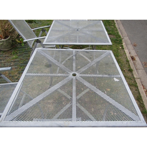 2038a - Two garden tables with grill tops raised on swept supports together with four folding chairs