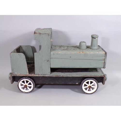 52 - A large vintage wooden toy train with wheels and painted finish, length 59cm (AF)
