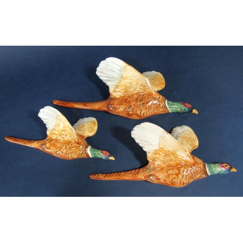 1038 - A set of three Beswick wall plaques in the form of pheasants in flight, smallest no 661-3, 21.5cm lo... 