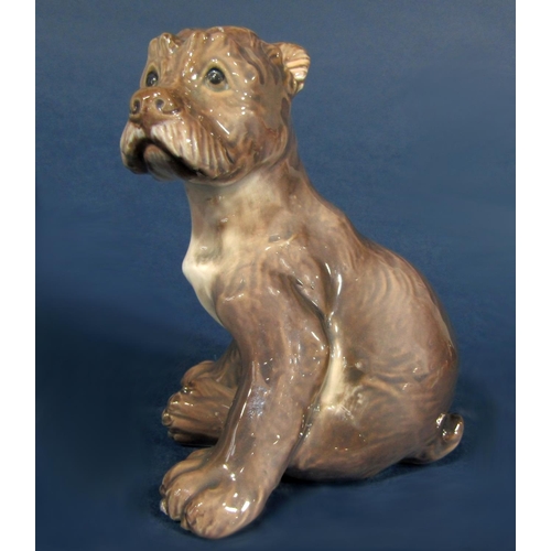 1057 - A Copenhagen model of a seated pup, with printed D J mark to base and painted numbers 1095, 13cm tal... 