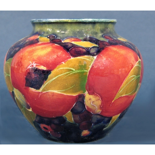 1059 - A Moorcroft vase of globular form with painted pomegranate and grape detail, impressed marks to base... 