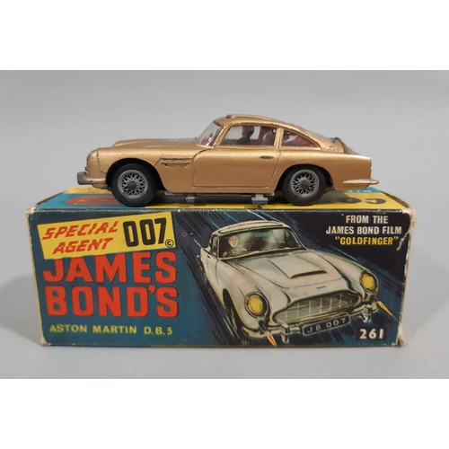 6 - James Bond's Aston Martin DBS by Corgi ©1965 261 featuring  functioning retractable machine guns and... 