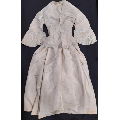 19th century 2 piece wedding dress circa 1840 in ivory moire silk; dress has low neckline, short sleeves, stayed fitted bodice forming a point at the centre front,  laced at the back and lined with cotton. Skirt is full and pleated at the waist. Jacket is stayed and tight fitting, with hook and eye front fastening. Sleeves open to a funnel shape with cuffs and jacket front trimmed with moire silk ruffle. Skirt length 104cm. Jacet waist 22"/56cm