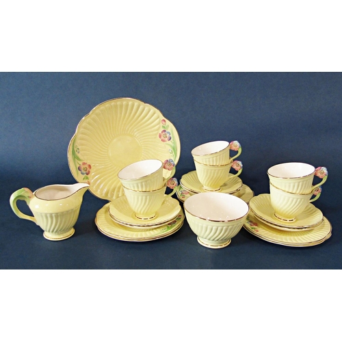 39 - A collection of Crown Devon yellow ground teawares with floral moulded handles comprising sugar bowl... 