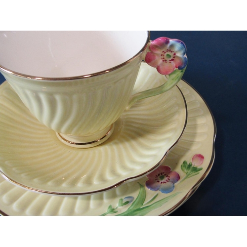 39 - A collection of Crown Devon yellow ground teawares with floral moulded handles comprising sugar bowl... 