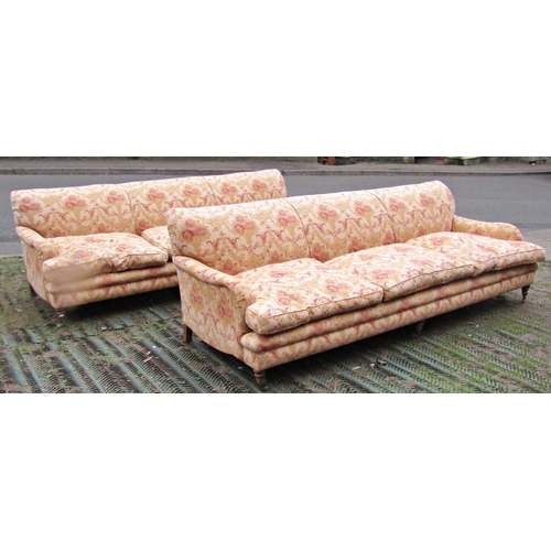 1350 - A pair of large country house size Howard style sofas with shaped outline, repeating scrolling flora... 