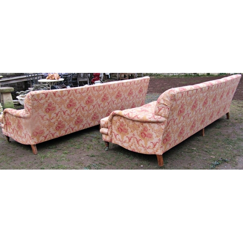 1350 - A pair of large country house size Howard style sofas with shaped outline, repeating scrolling flora... 