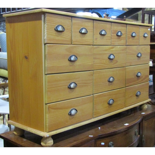 A modern pine dresser fitted with an arrangement of fifteen Barnebys
