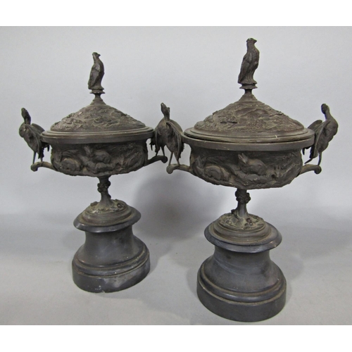 607 - A pair of bronze 19th century tazzas with covers mounted on stands decorated with gun dogs and game ... 