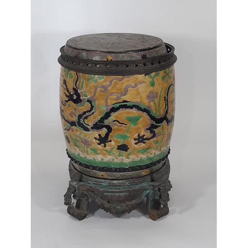 1065 - A 19th century Chinese ceramic barrel with trailing dragon, cloud and pearl detail, mounted within a... 