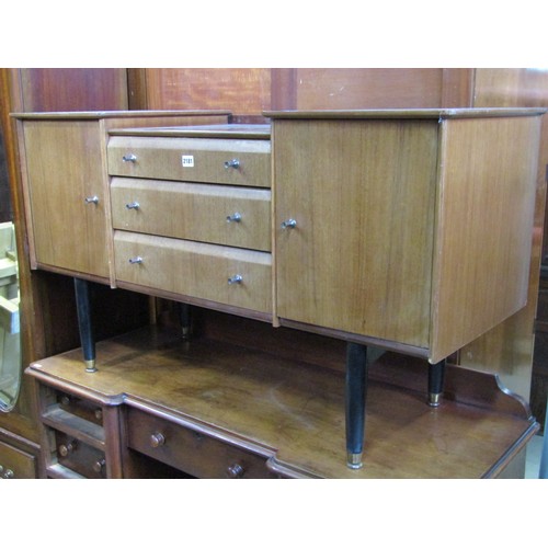 A Nathan teak dressing table with shallow drop well over other three central drawers flanked by cupboards raised on ebonised tapered supports (AF) 122cm