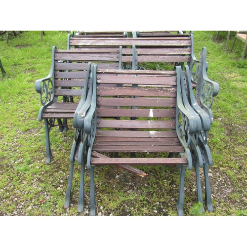 A suite of garden furniture with decorative mat painted open scrolling foliate pattern cast iron end supports and weathered hardwood lathes (af) mainly for recommissioning, comprising two seat bench and five chairs (6)