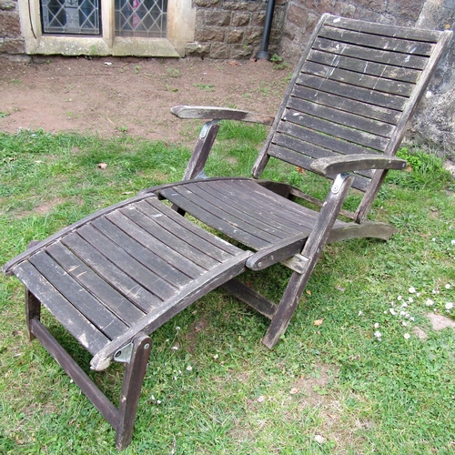 A weathered stained hardwood folding  steamer type garden armchair with  slatted, seat, back and foot rest (af)