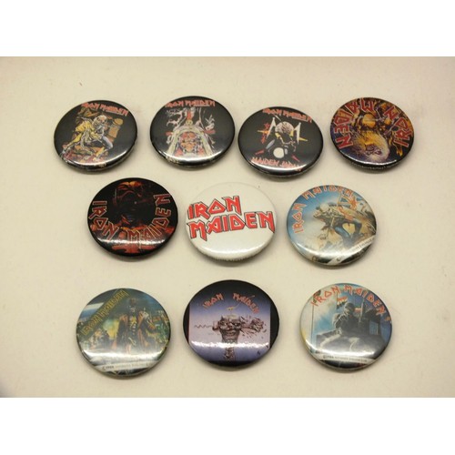 39 - JOB LOT OF IRON MAIDEN COLLECTABLE BADGES AND VHS TAPES
