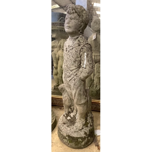 1005 - A reconstituted stone garden ornament of a boy with dog, height 69cm