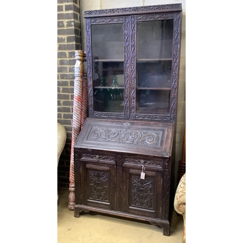 1018 - A Victorian carved oak bureau bookcase, width 94cm, depth 54cm, height 203cm