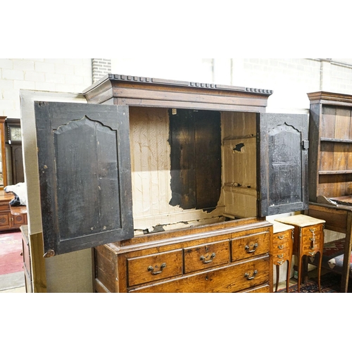 2 - A George III oak press cupboard, with moulded cornice and two panelled doors over five drawers, widt... 