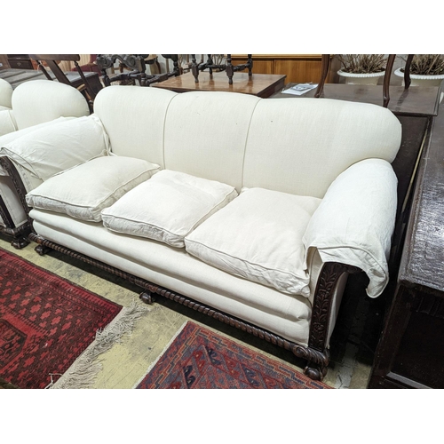 54 - An early 20th century carved mahogany upholstered three piece lounge suite on claw and ball feet, th... 