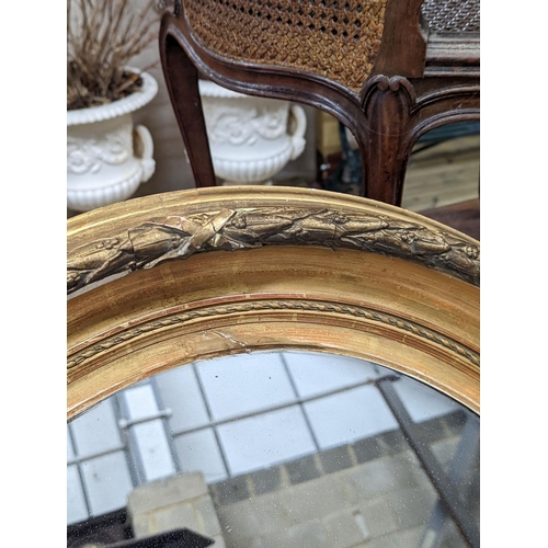 55 - A Victorian oval giltwood and gesso wall mirror, width 80cm, height 94cm