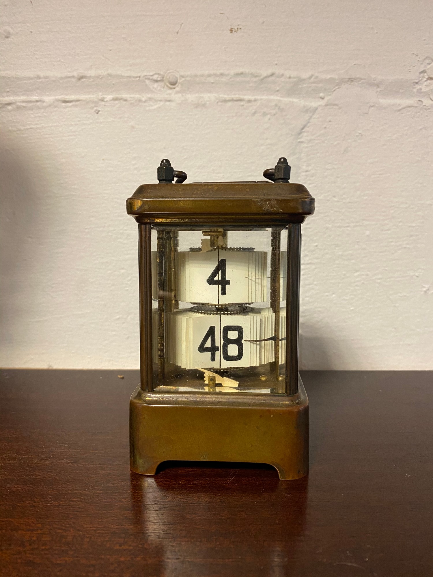 A brass cased flicker/ticker style clock