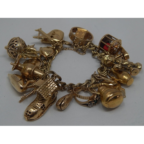 334 - Heavy 9ct Gold Charm Bracelet with 22 Charms: Gross Weight 67.8g