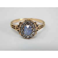 Victorian 18ct Yellow Gold Ring Set with a Central Sapphire within a Diamond Border. Size N: Weight 2.9g