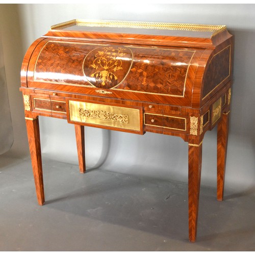 613 - A French style marquetry inlaid and gilt metal mounted bureau, the low brass gallery above a cube an... 