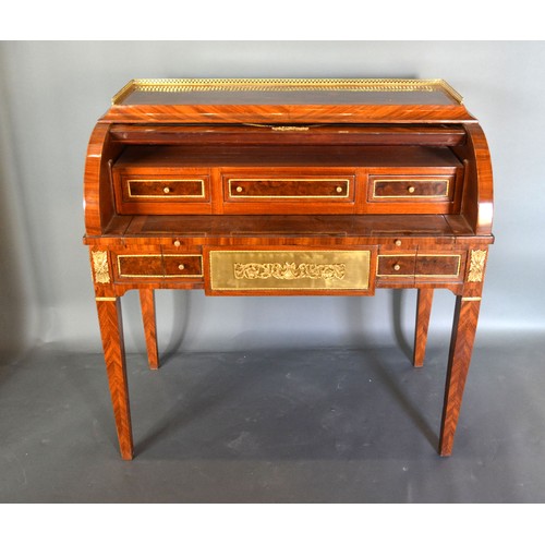 613 - A French style marquetry inlaid and gilt metal mounted bureau, the low brass gallery above a cube an... 