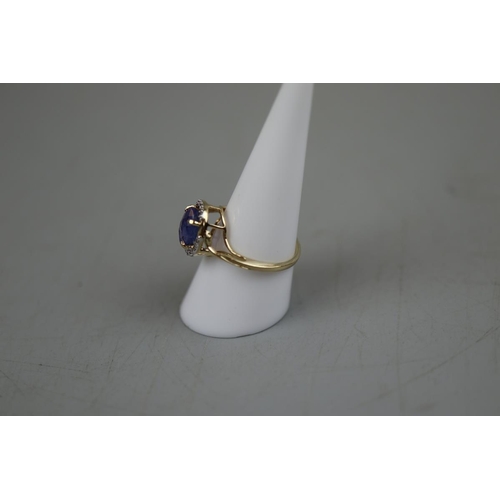 51 - Gold tanzanite and diamond set ring - Approx. size: P