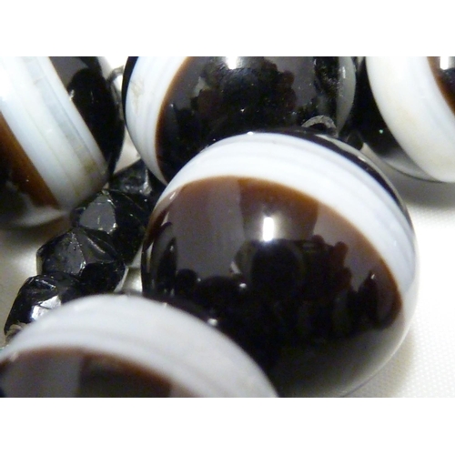 A banded agate necklace, of 23 black 