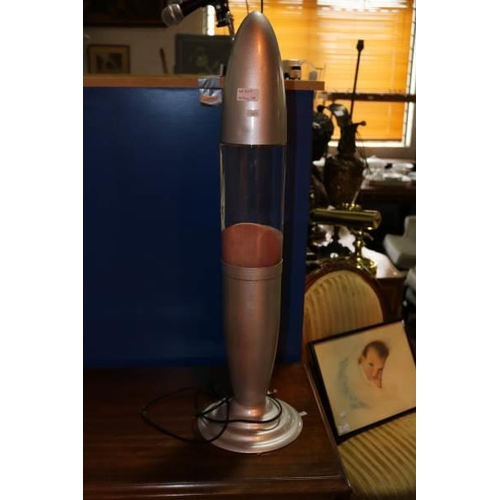 Large rocket shaped Lava-lamp together with a quartz cine ...