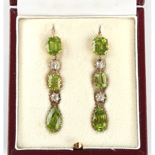 5 - A good pair of peridot & diamond pendant earrings, for pierced ears, each with three cut peridots al... 
