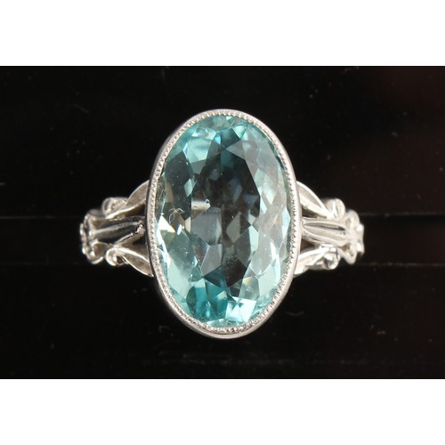 27 - An 18ct white gold aquamarine ring, the oval cut aquamarine weighing an estimated 5.60 carats, in mi... 