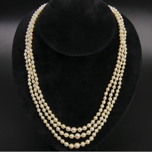 18 - Cultured Pearl graduated triple strand necklace with a 9ct gold and Amethyst clasp. UK Postage £12.