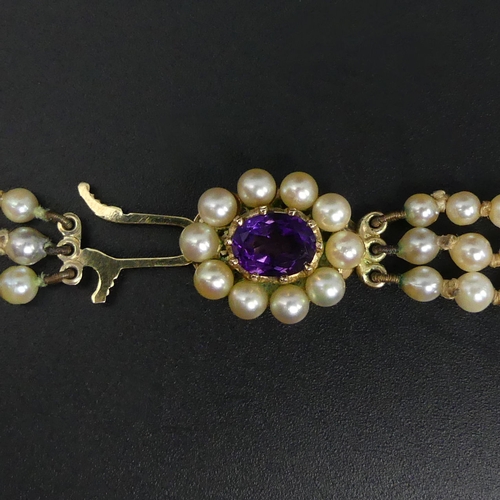 18 - Cultured Pearl graduated triple strand necklace with a 9ct gold and Amethyst clasp. UK Postage £12.