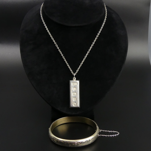 23 - Sterling silver hinged bangle and a silver ingot pendant and chain. 54 grams. UK Postage £12.